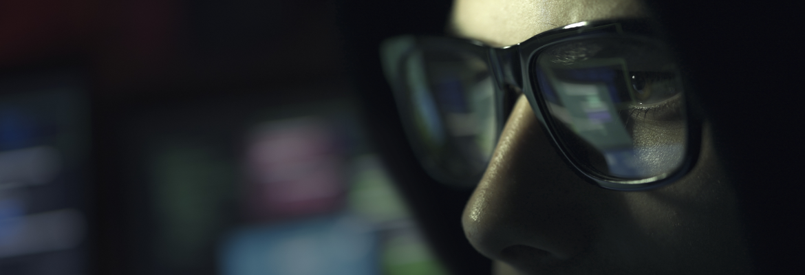 man wearing glasses close up dark background